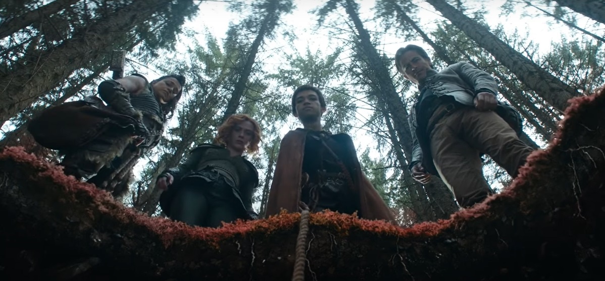 Equipo de Calabozos y Dragones viendo a un agujero en el suelo